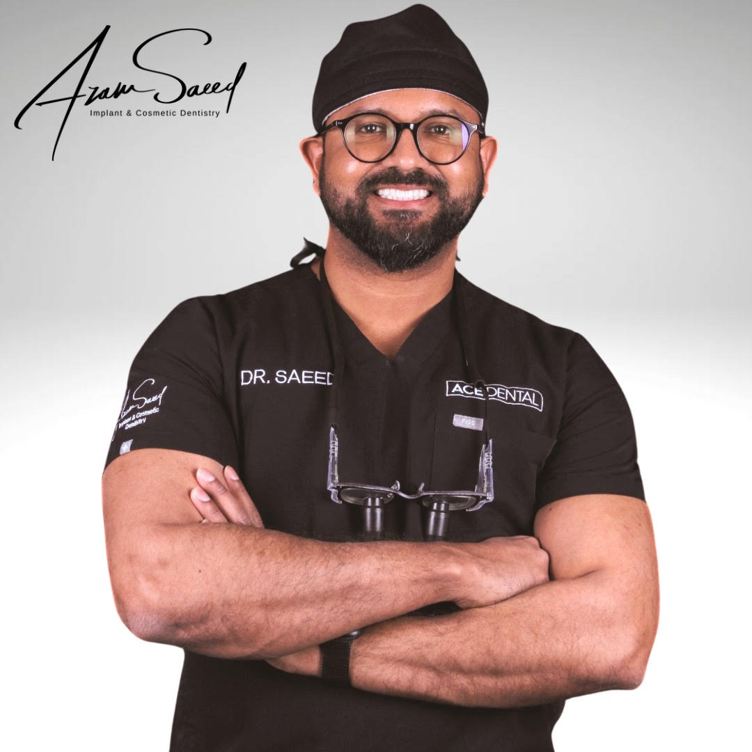 dr azam smiling with arms crossed