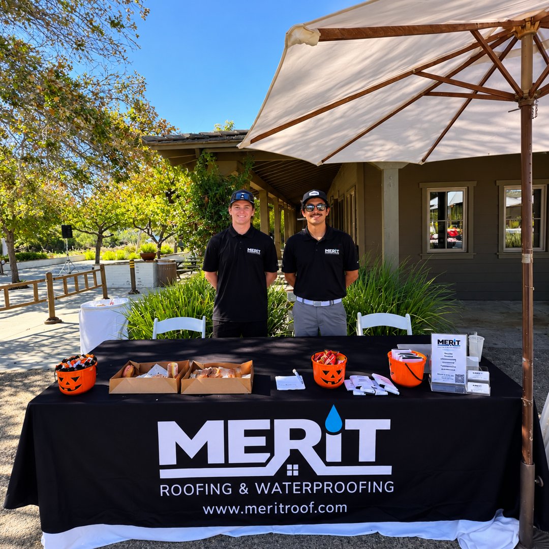 Merit Roofing team members at a community event booth