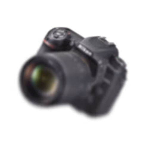 Black DSLR camera with a large lens on a black background.