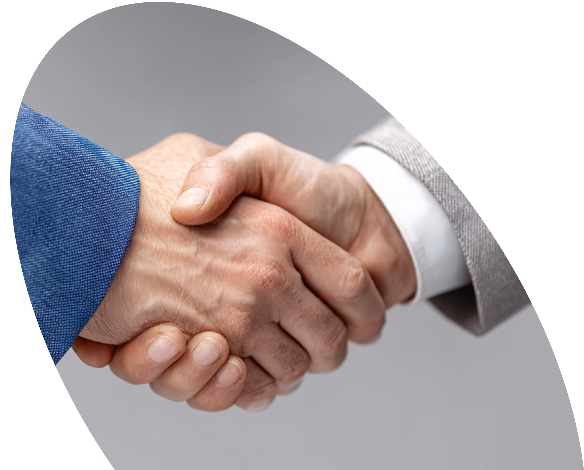 Two people shaking hands, one wearing a blue suit and the other a light grey suit.