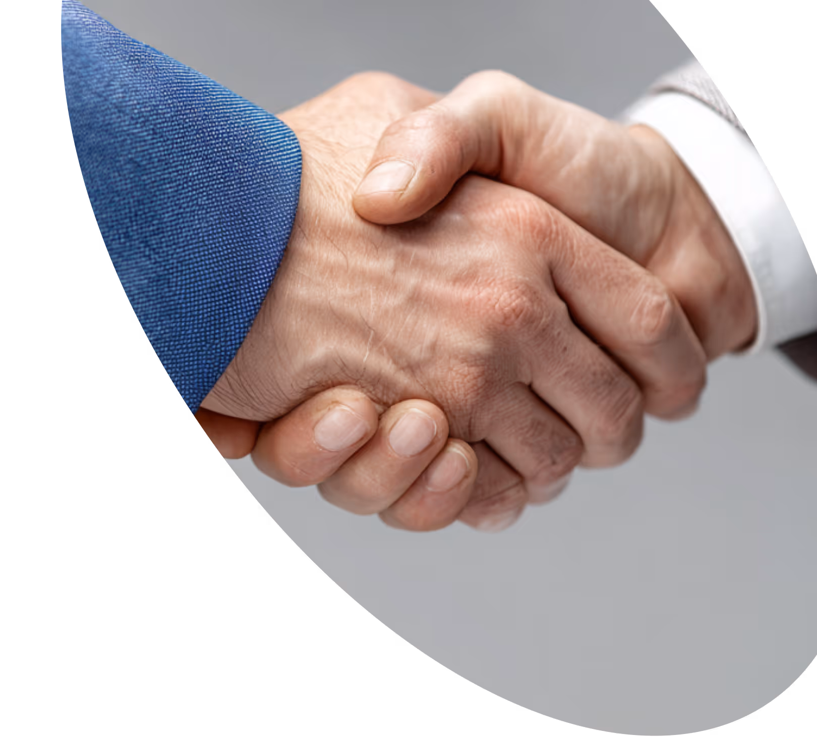 Two people shaking hands, one wearing a blue suit and the other a light grey suit.