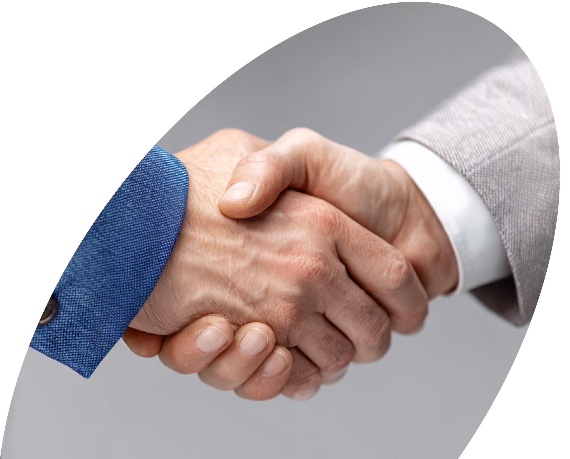 Two people shaking hands, one wearing a blue suit and the other a light grey suit.