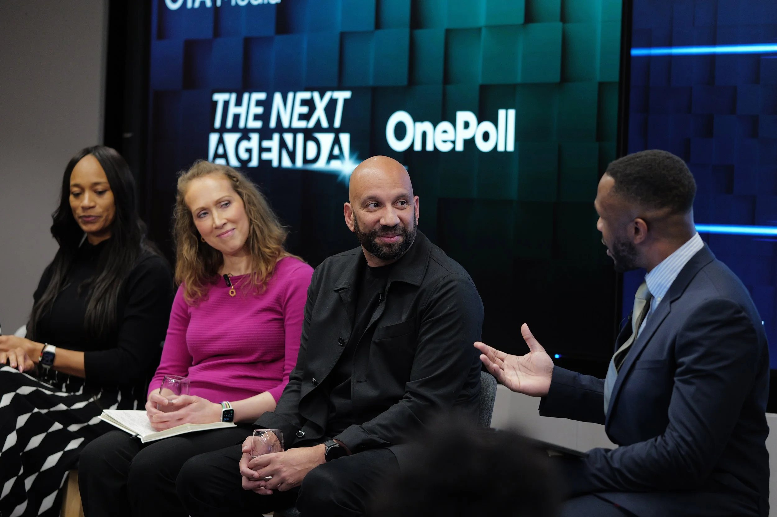 Four panelists seated and engaged in discussion during a talk show with THE NEXT AGENDA and OnePoll logos in the background.