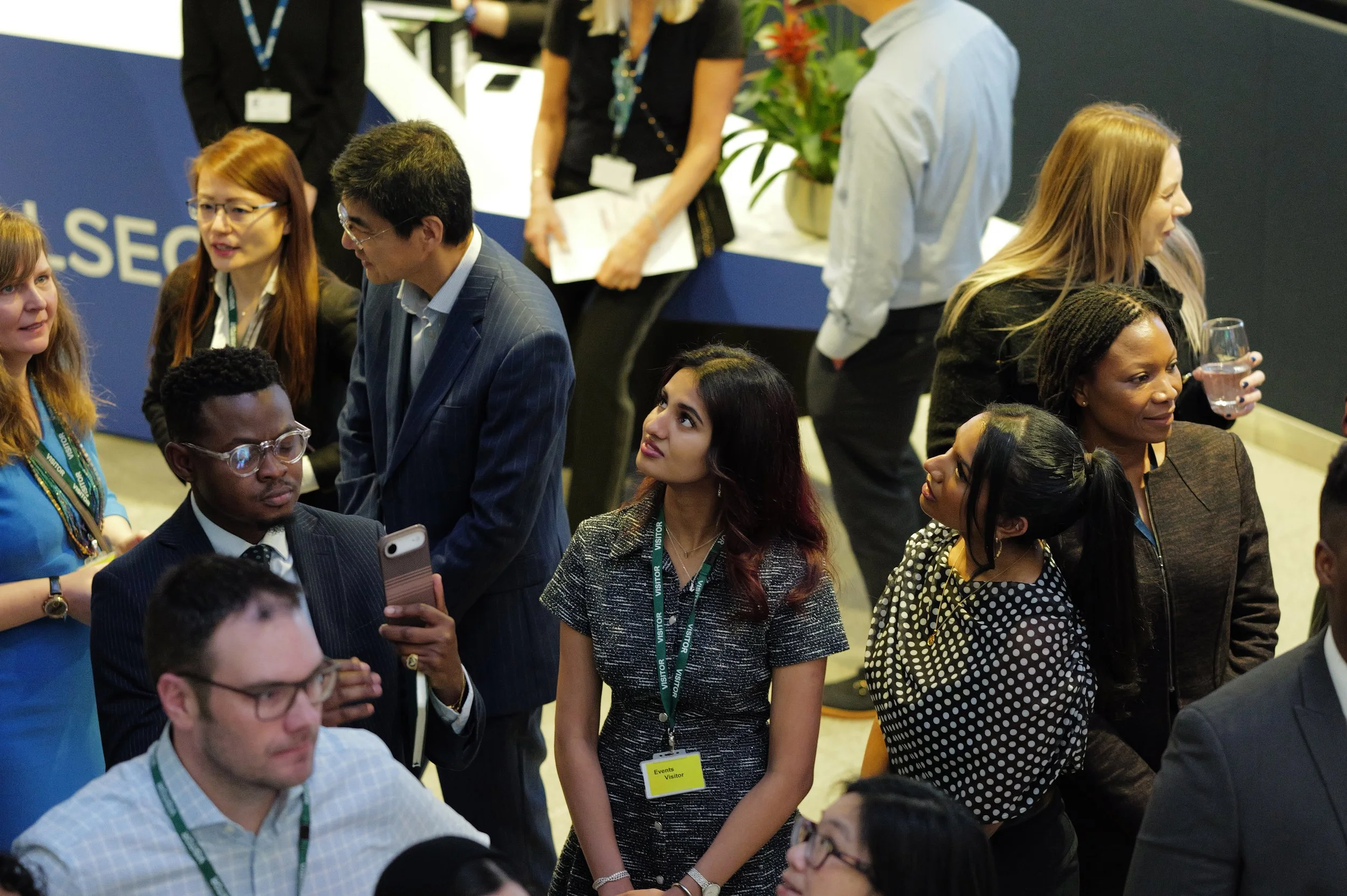 Group of diverse professionals engaging and networking at an indoor event.