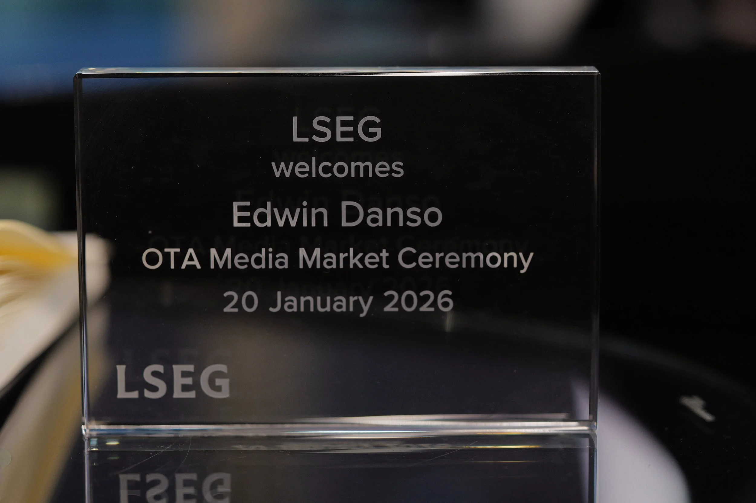 Glass plaque with engraved text welcoming Edwin Danso to the OTA Media Market Ceremony on 20 January 2026, branded with LSEG.