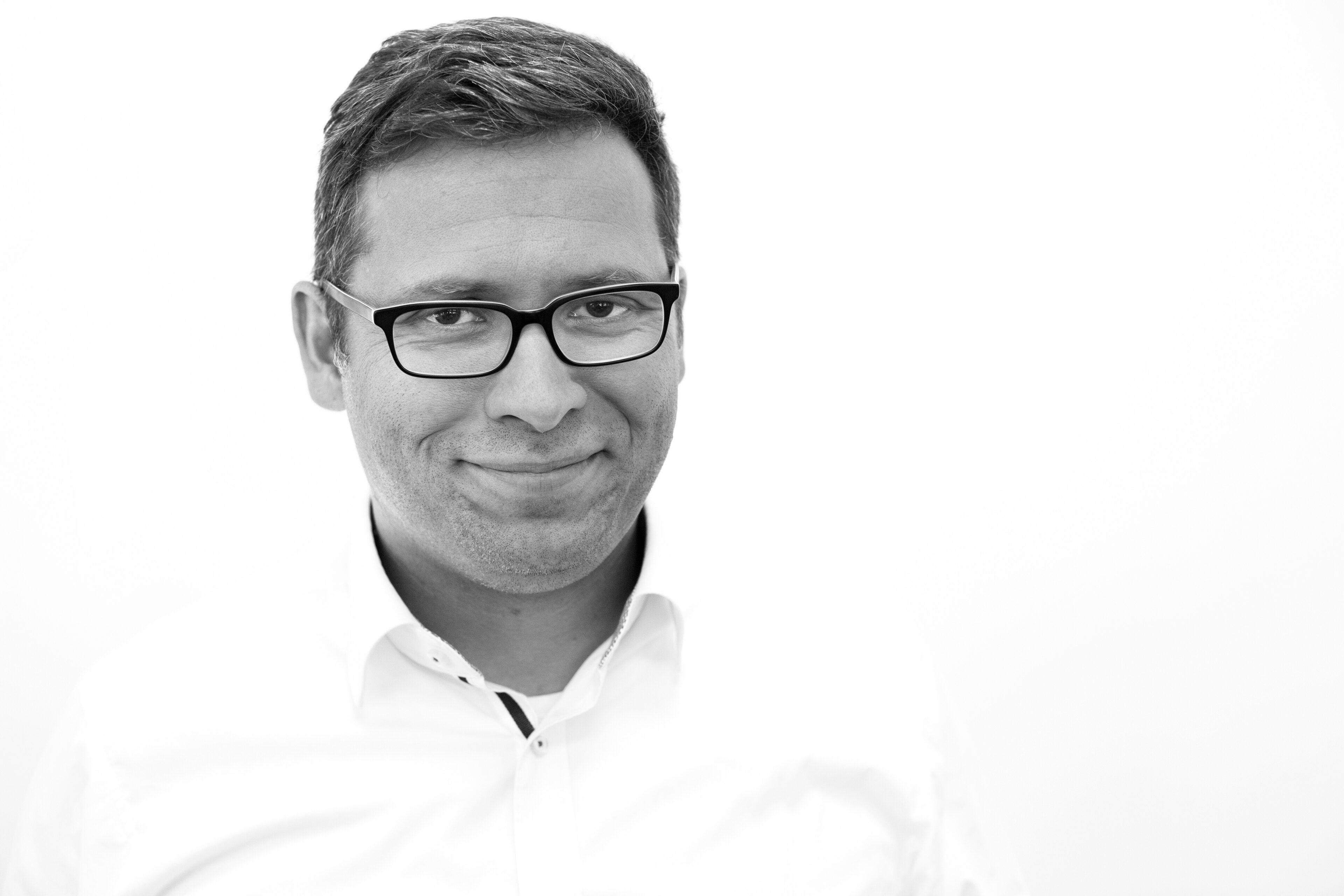 Man with glasses looking towards the camera