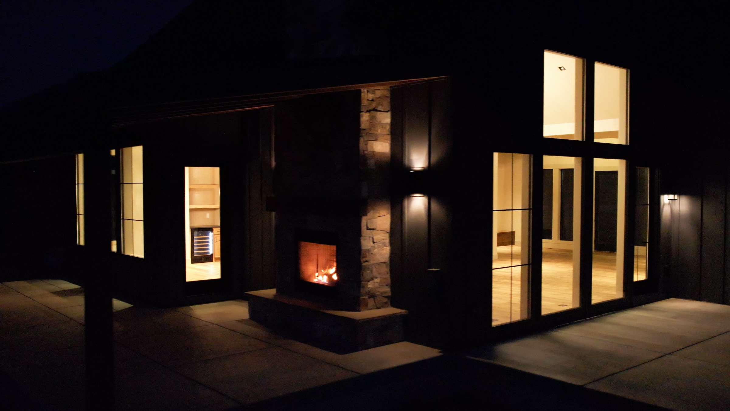 Timber Creek, the back patio and exterior fireplace at night