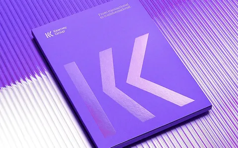 Purple booklet with metallic logo and text reading 'Kearney Group' and 'From transactional to transformational' on a ribbed purple and white surface.