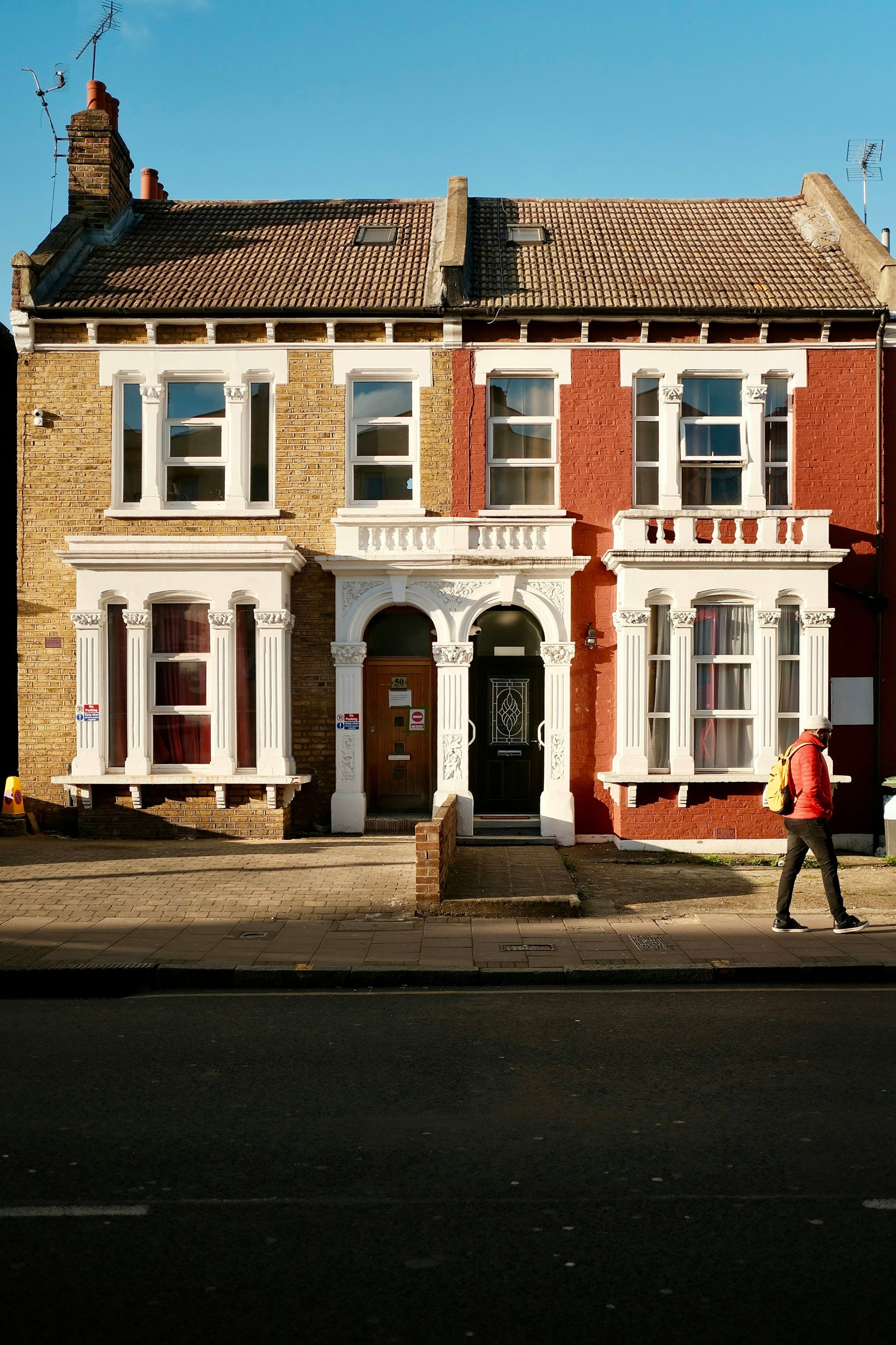 Black front door and chequered steps on a white stucco house