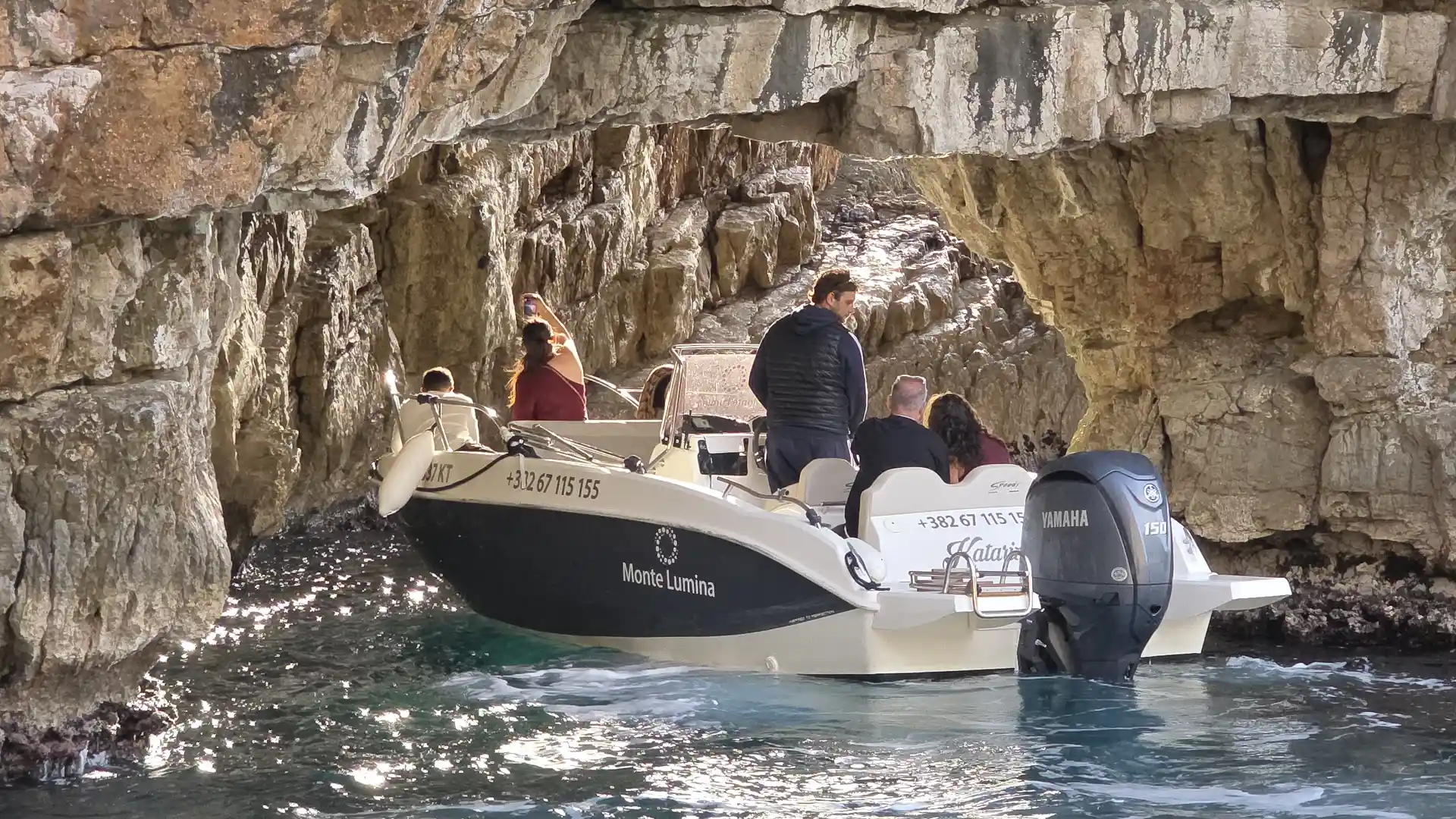 Group of visitors snorkeling and enjoying the Blue Cave water in Montenegro