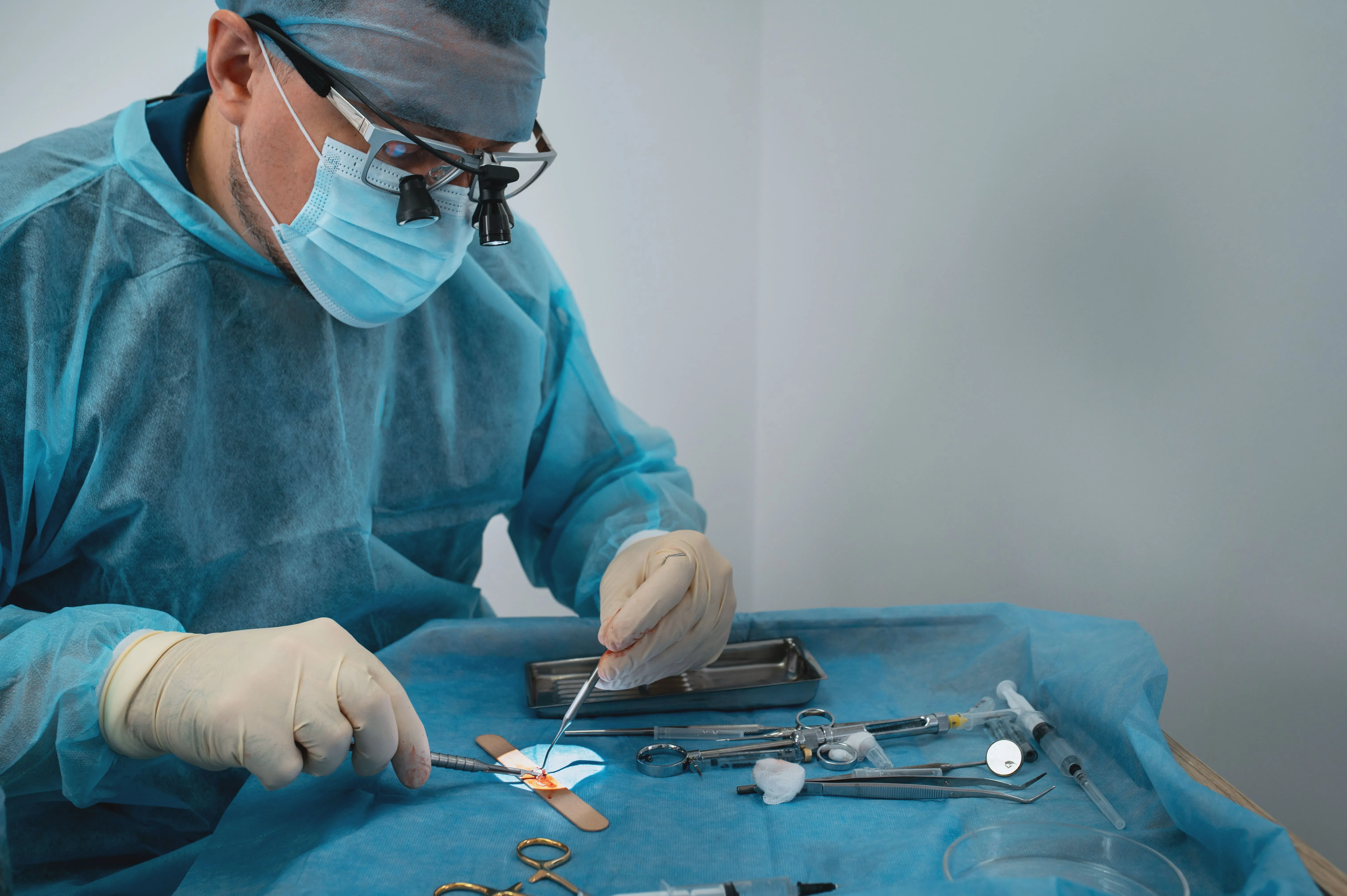 Oral surgeon preparing instruments for a dental procedure