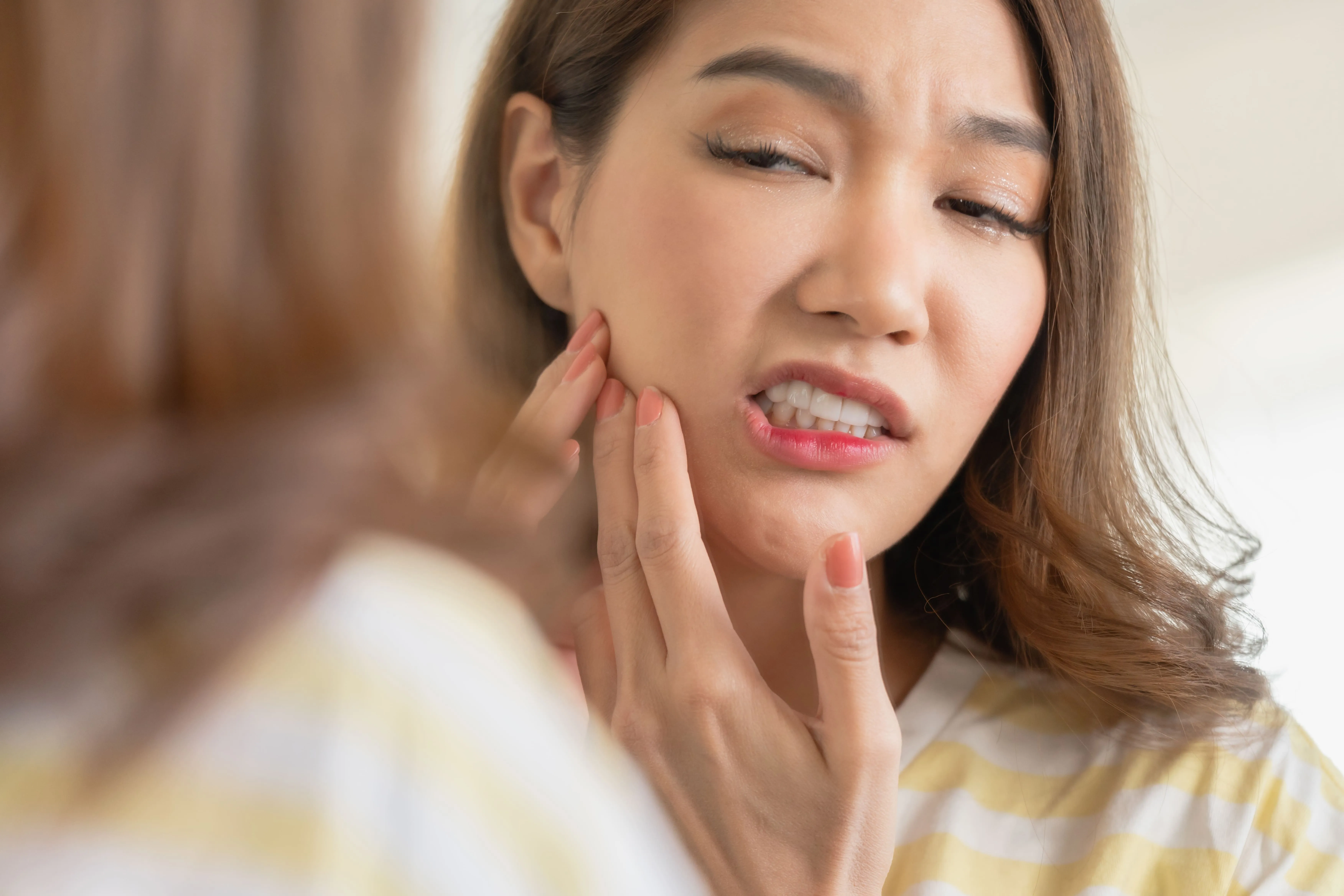 Patient experiencing upper jaw discomfort before dental evaluation