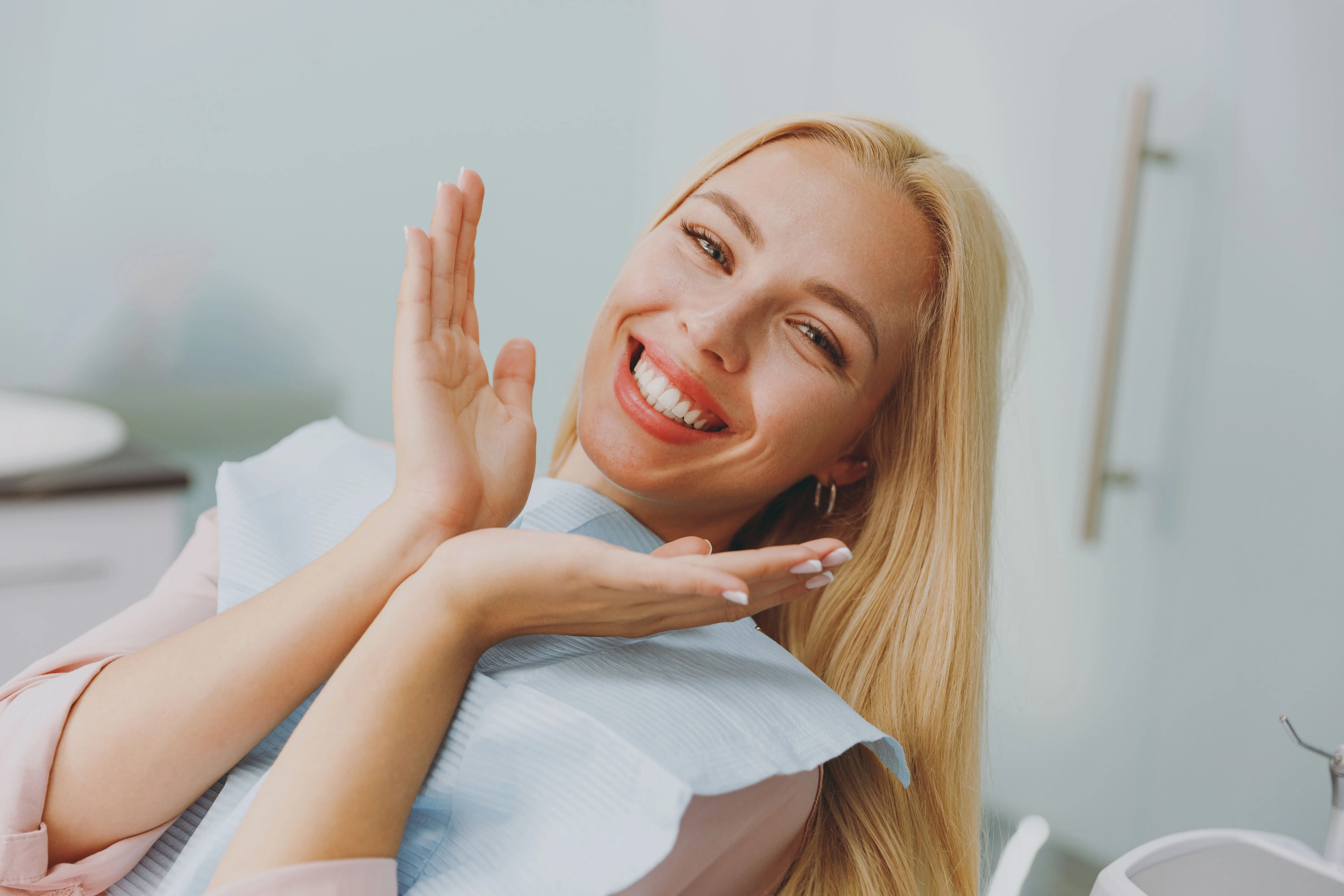 Patient smiling in a dental chair after treatment