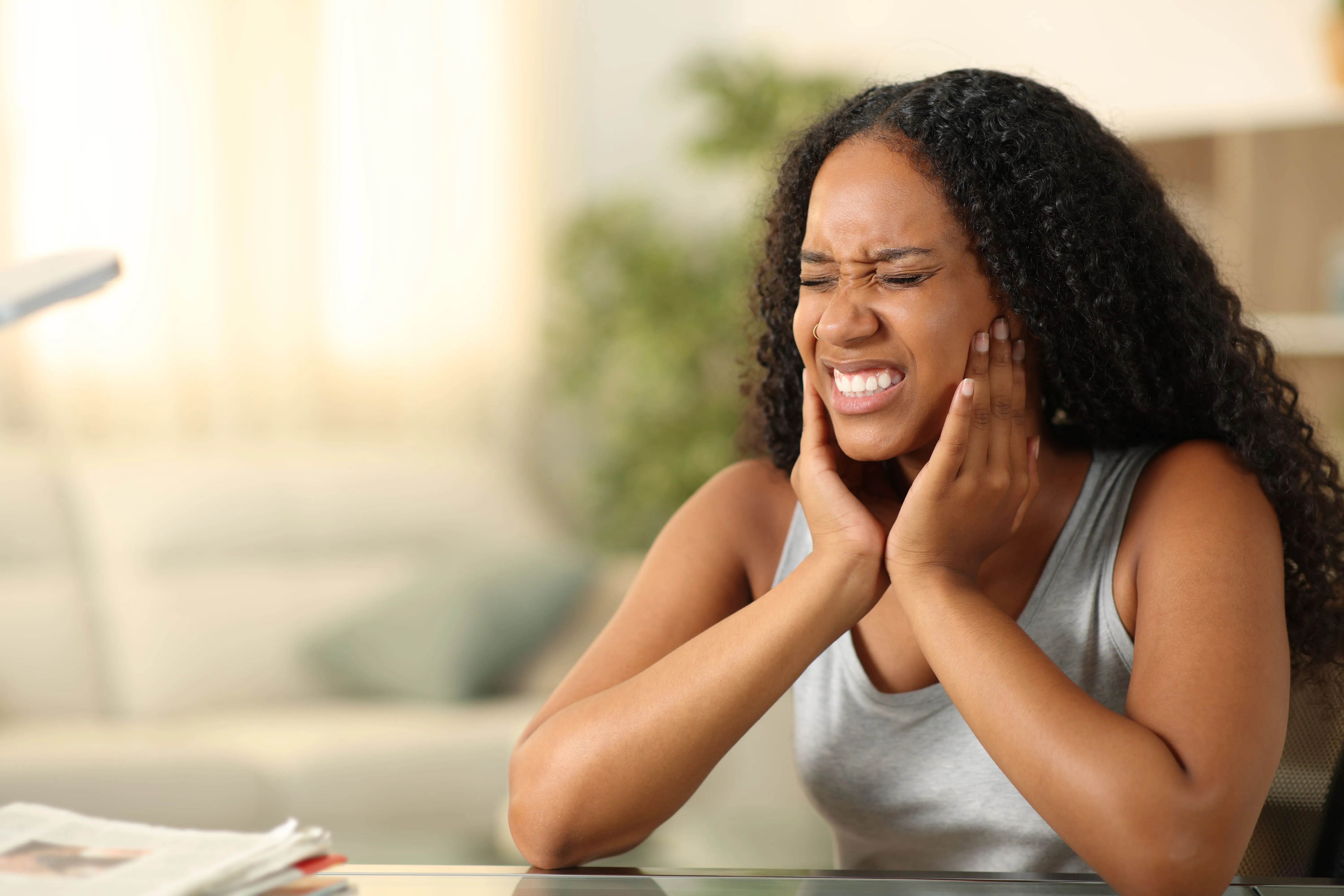 Patient experiencing jaw pain associated with a TMJ disorder