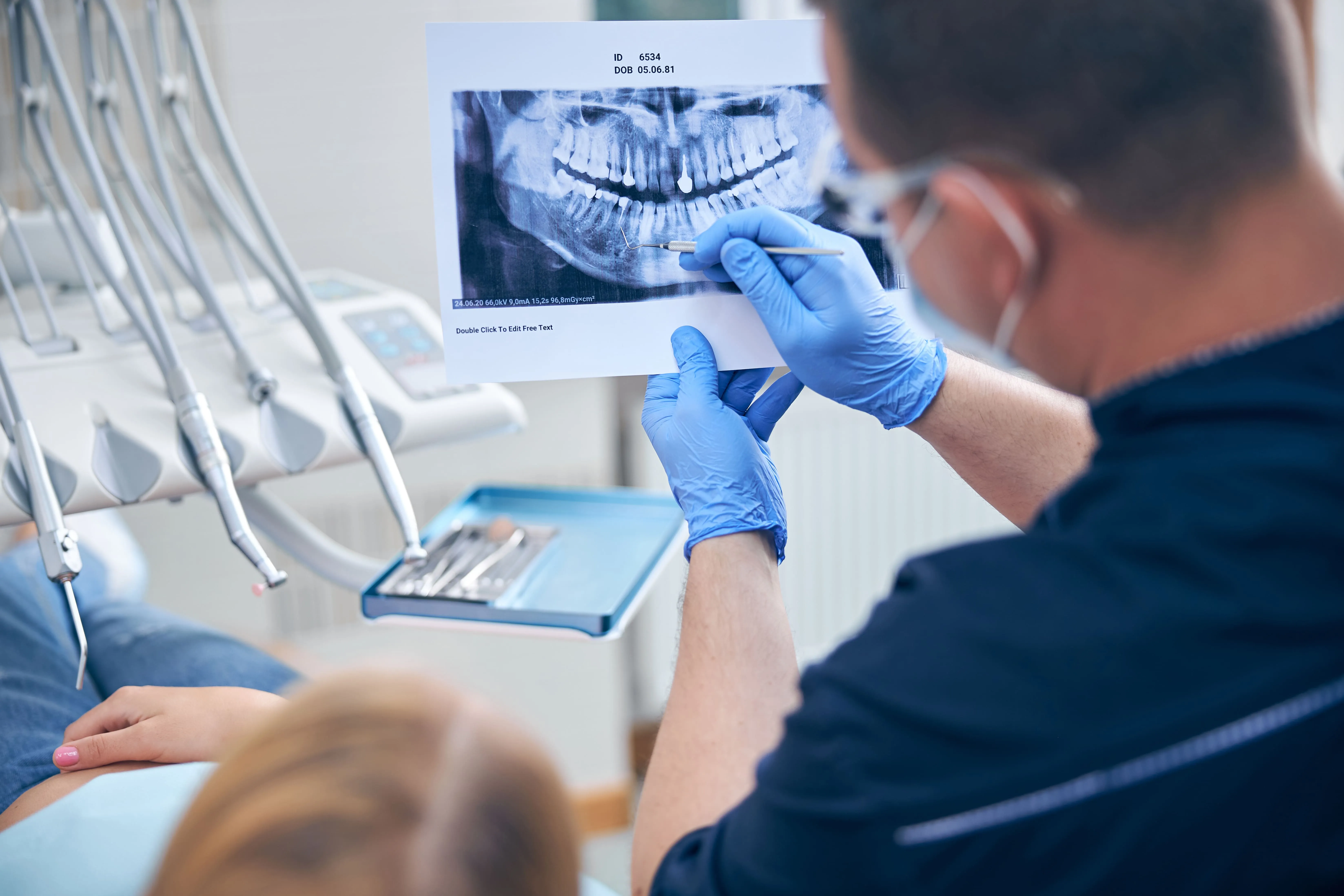 Oral surgeon reviewing a panoramic dental X-ray