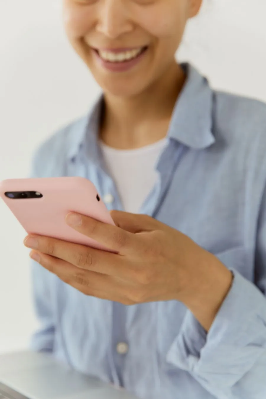 Woman booking a teeth whitening appointment on her phone