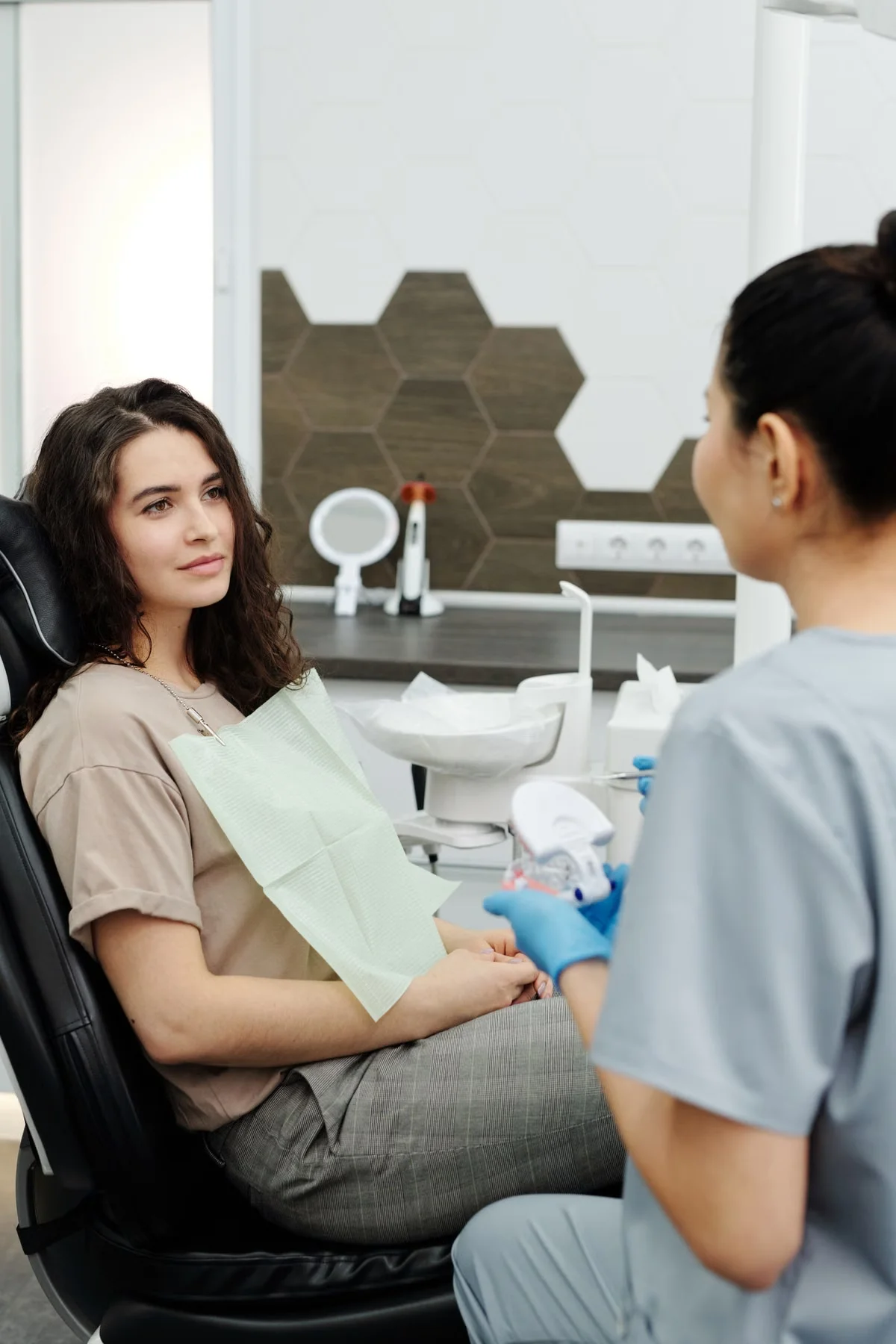 Dentist having a one-on-one consultation with a patient in the dental chair