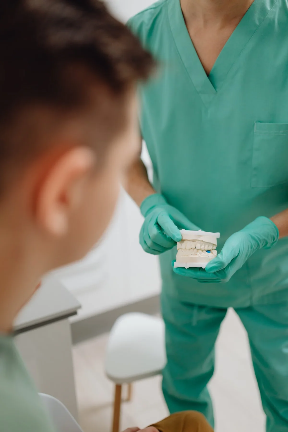 Dentist holding a dental model to explain a new smile design