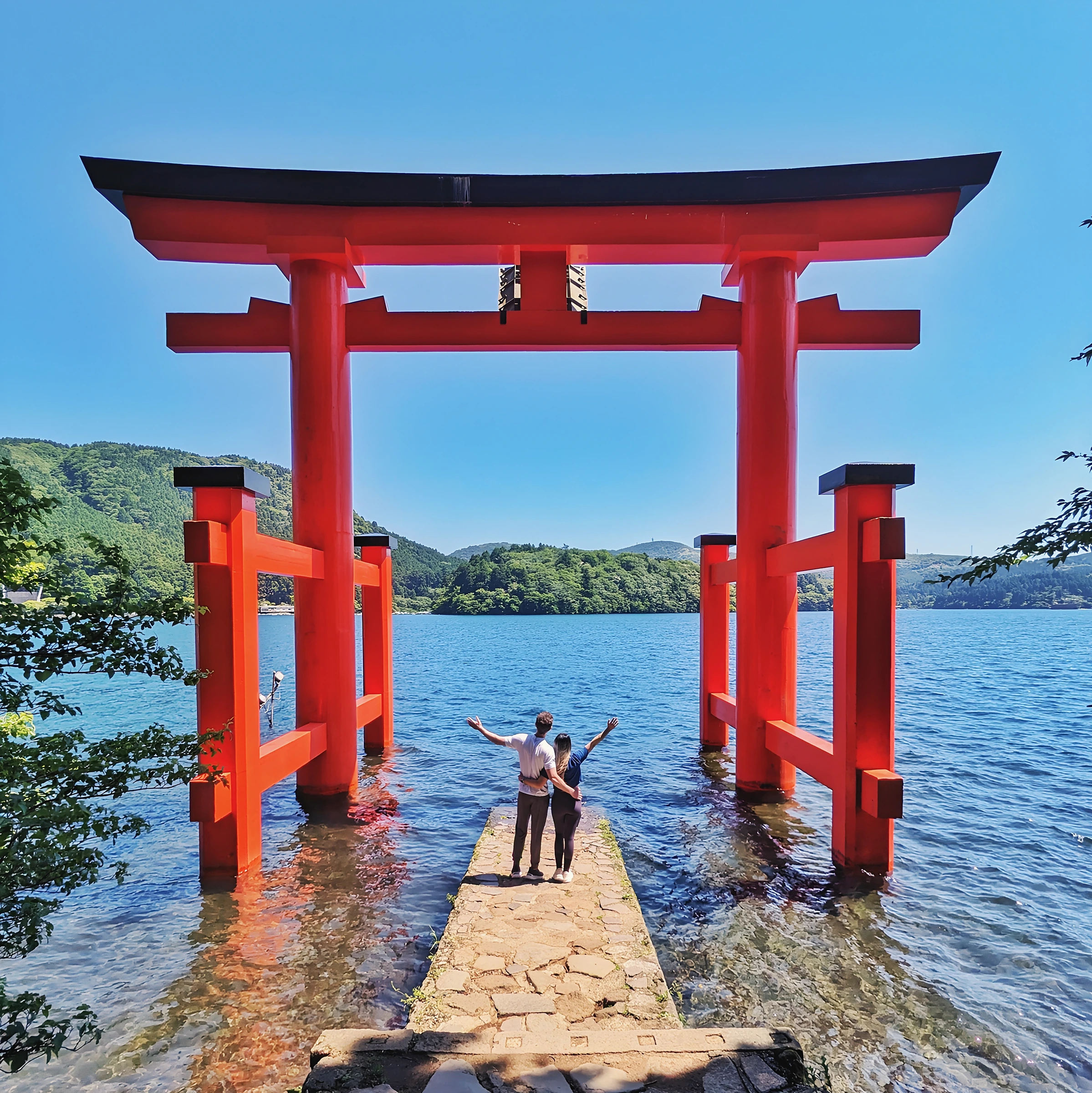 Dr. Gloria Luong and her partner at the Hakone Shrine torii gate on Lake Ashi, Japan