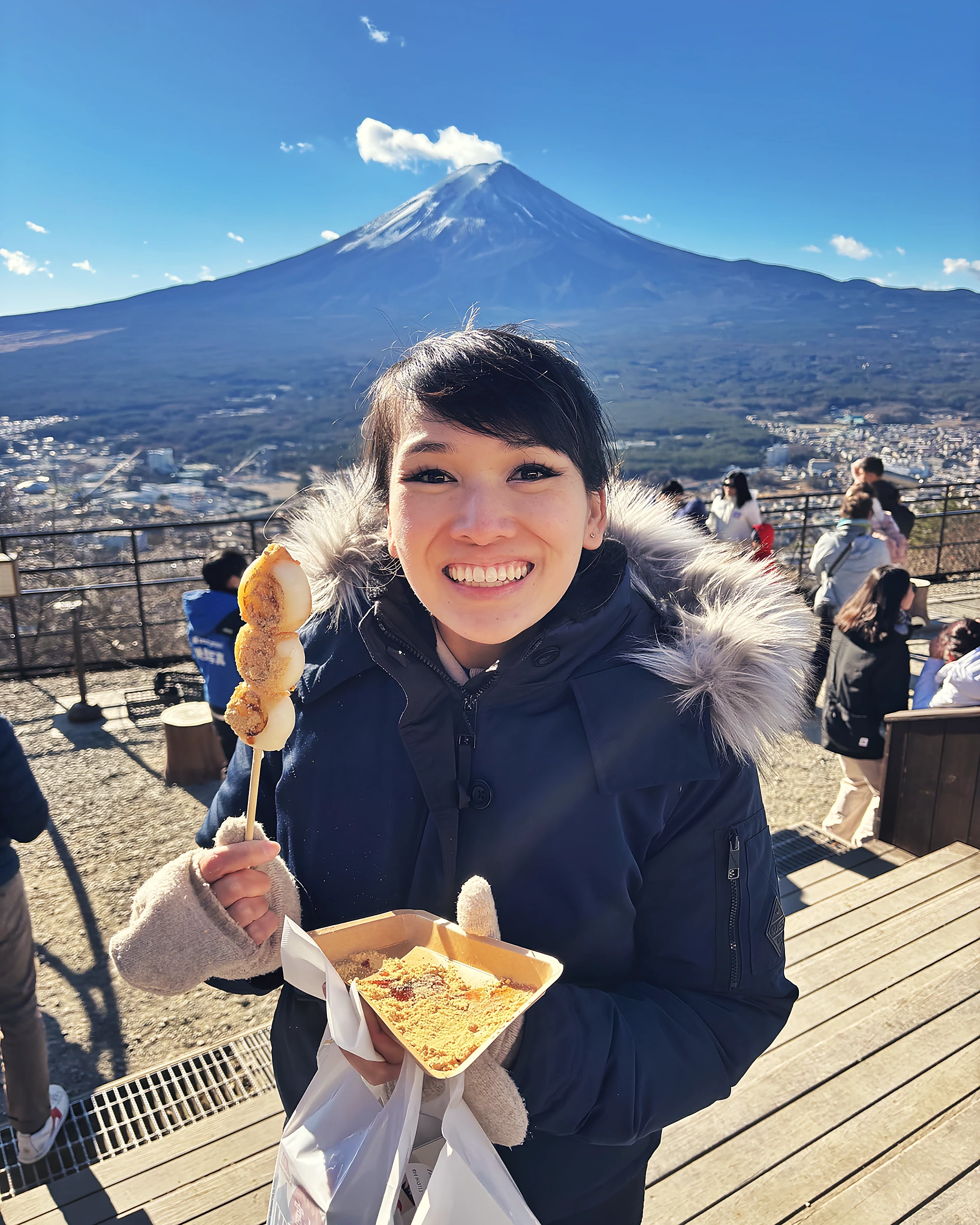 Dr. Gloria Luong enjoying dango with Mount Fuji in the background