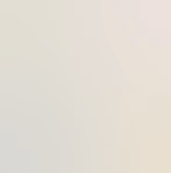 Tall red sandstone rock formations illuminated by sunlight in a desert landscape.