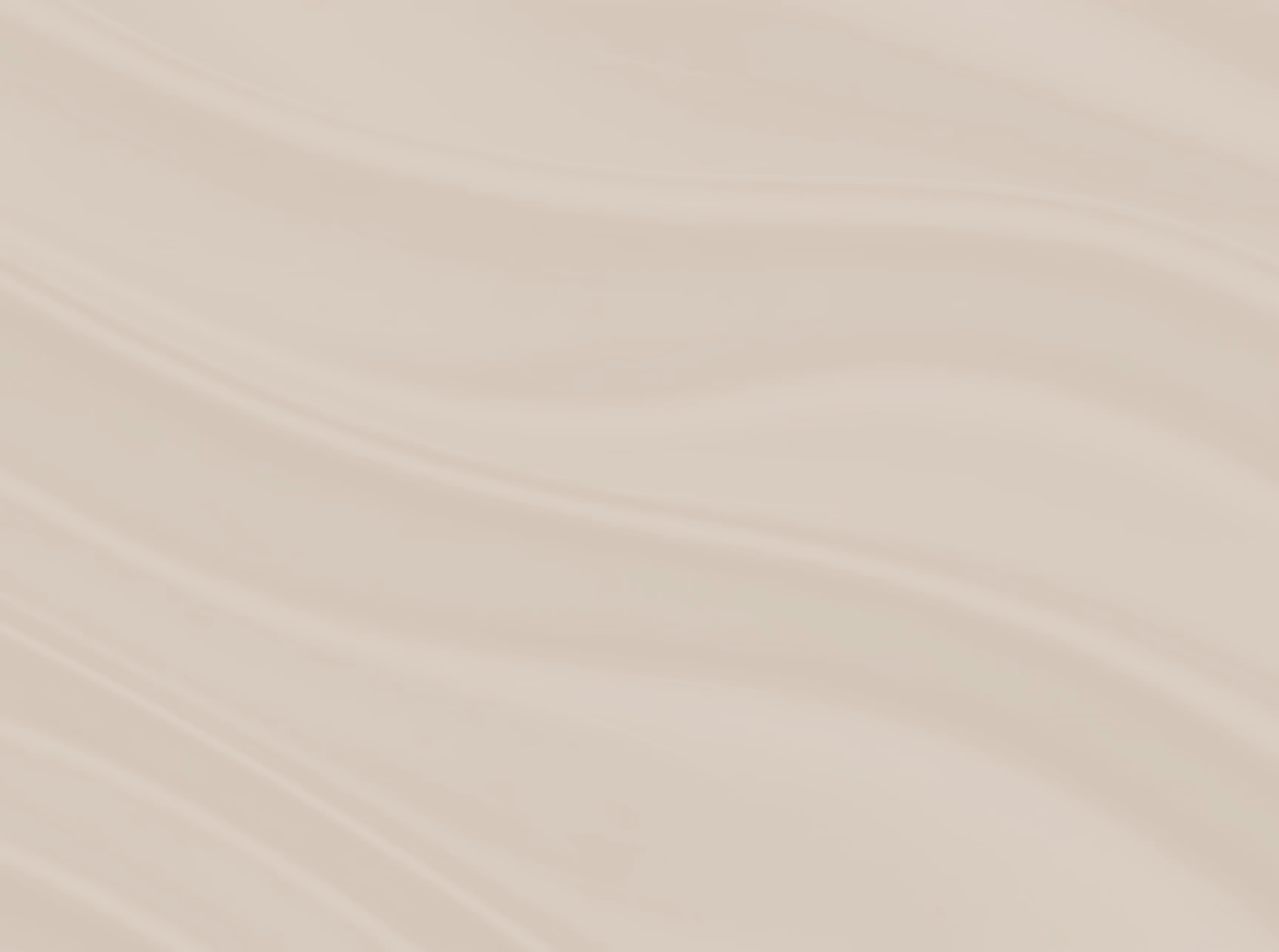 Close-up of smooth, creamy brown silk fabric with gentle folds and soft sheen.