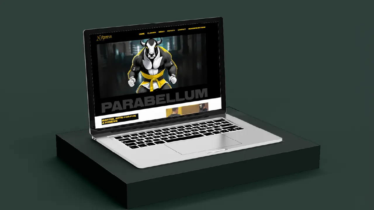 Open laptop on black platform showing Parabellum martial arts website with bull mascot and menu.
