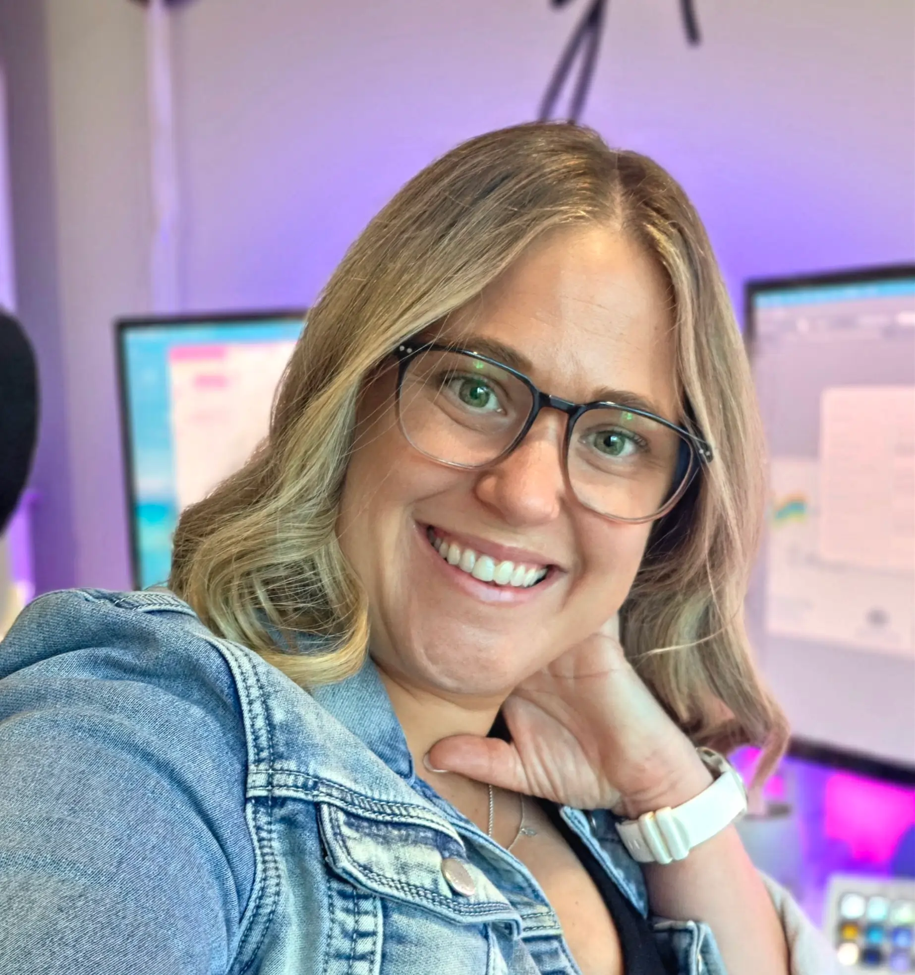 Kat Price in front of computer screens.
