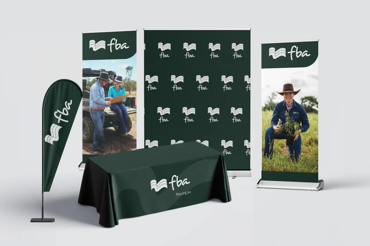 Branded FBA event kit with tablecloth, feather flag, and banners featuring farming images and logos.