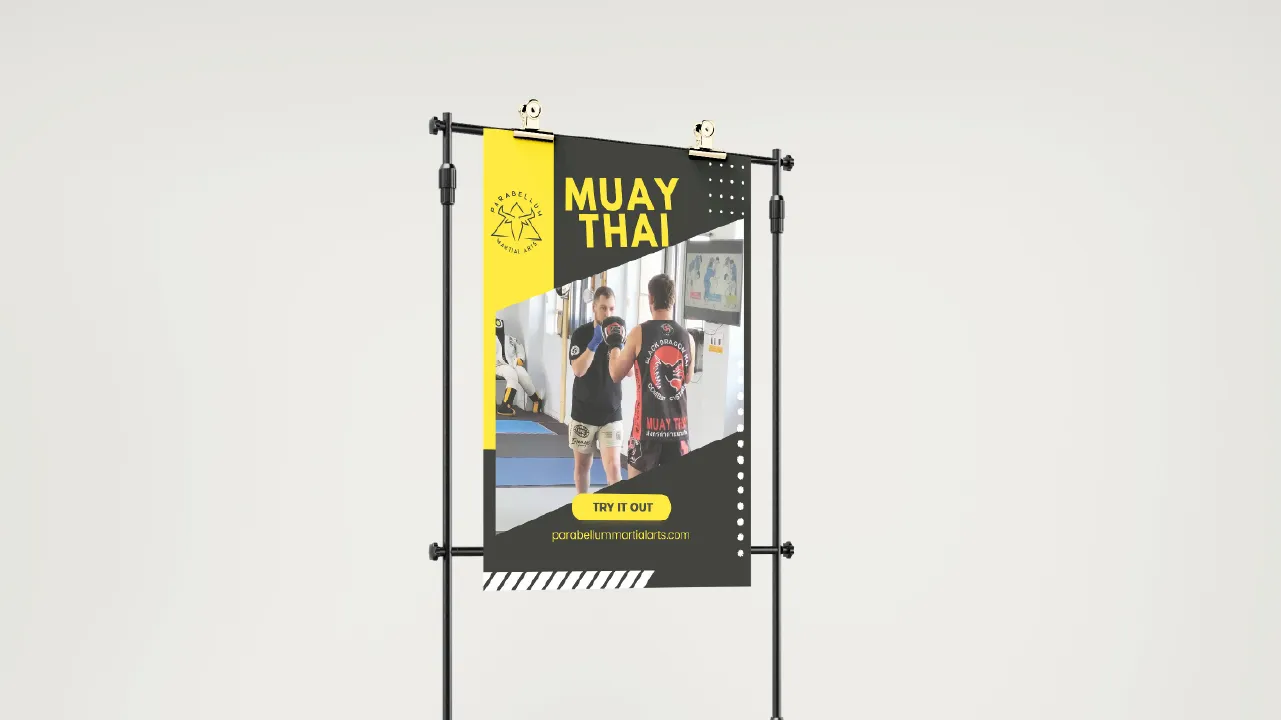 Muay Thai promotional banner showing two men training in a martial arts gym with website and try it out button.