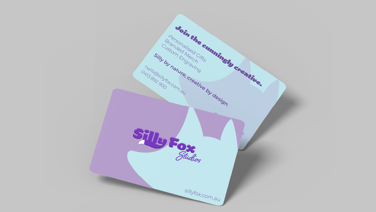 Two business cards for Silly Fox Studios featuring a stylized light blue fox head on a purple and light blue background.