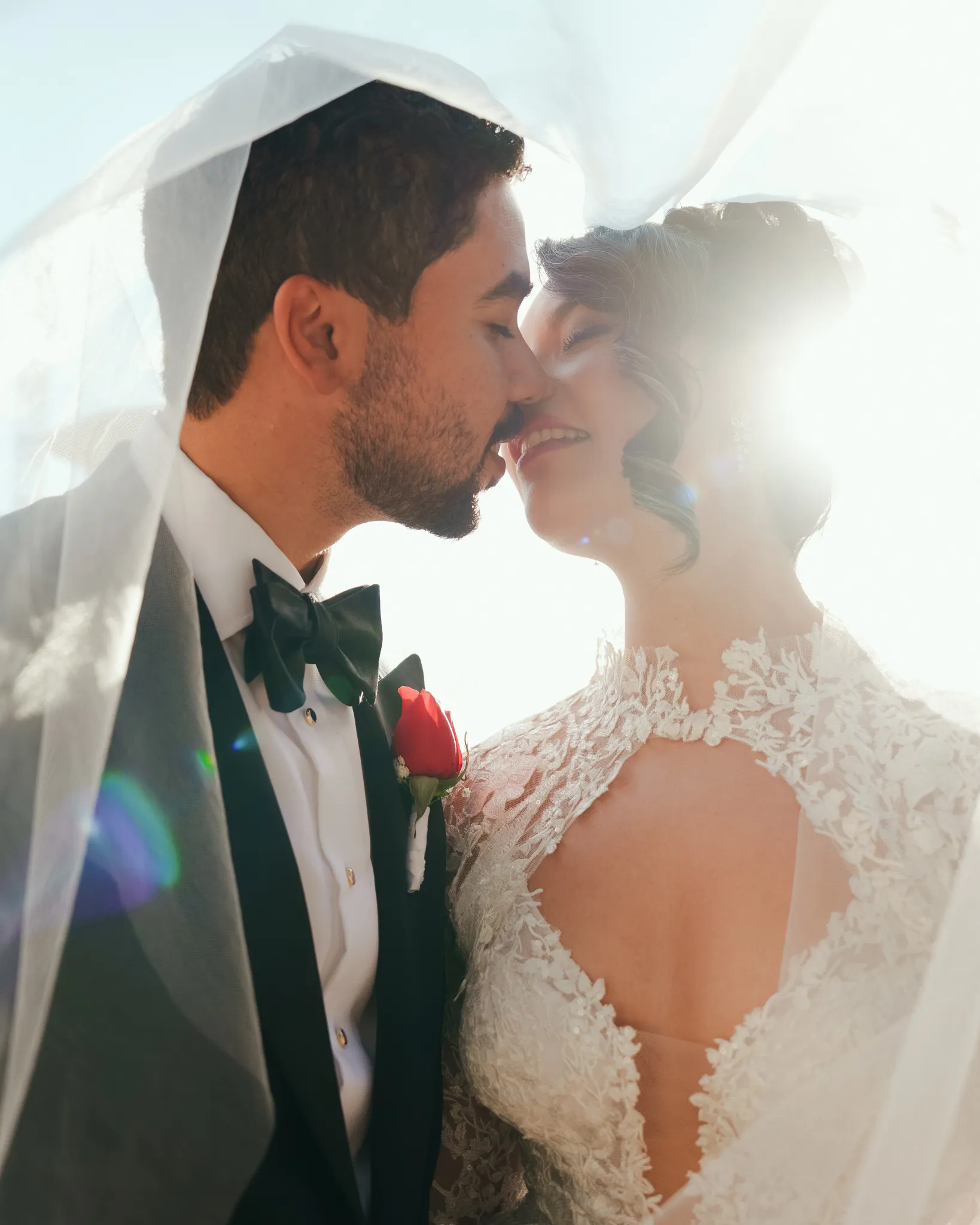 Austin Texas wedding photographer intimate close-up of bride and groom about to kiss with rainbow light flare