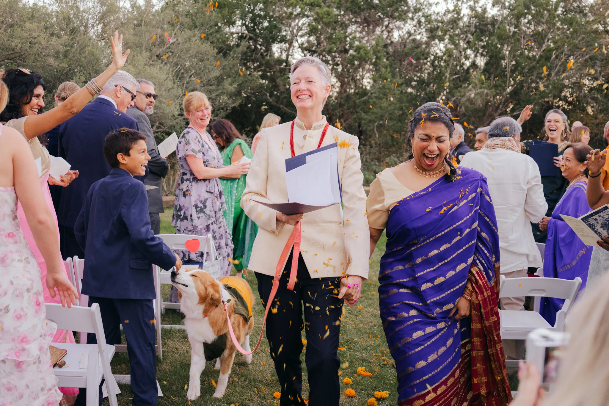 Austin Texas wedding photographer joyful outdoor ceremony with two brides one wearing a purple sari