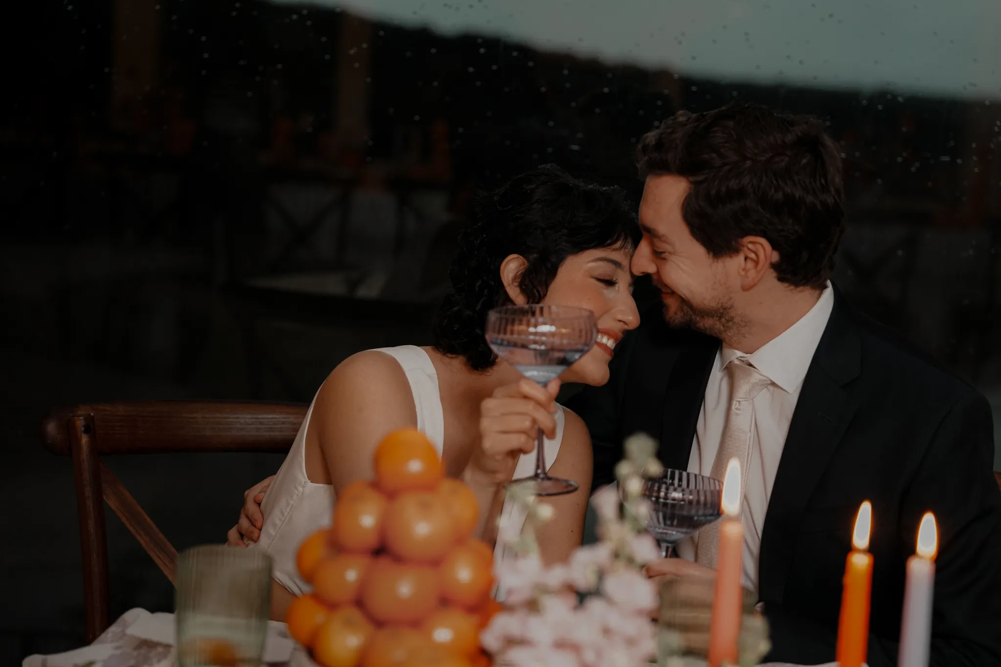 Austin Texas wedding photographer captures groom lifting bride in a bohemian fringe dress at golden hour in a Hill Country field