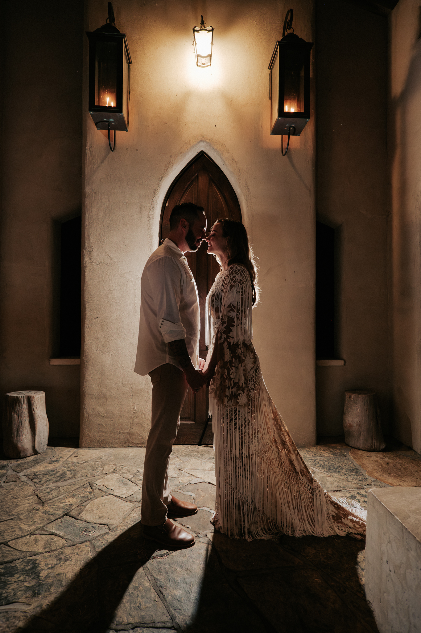 Bride and groom sharing an intimate moment in the doorway of Chapel Dulcinea, Austin Texas wedding photography by Moments By Marcela