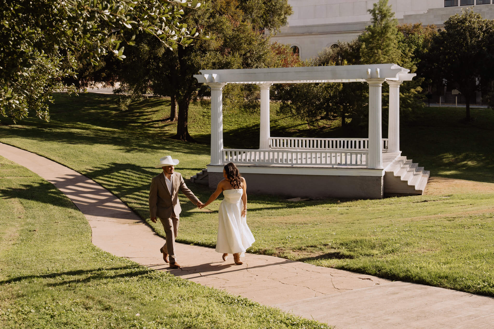 Bride laughing as groom whispers in her ear during their Austin Texas wedding, candid documentary photography by Moments By Marcela