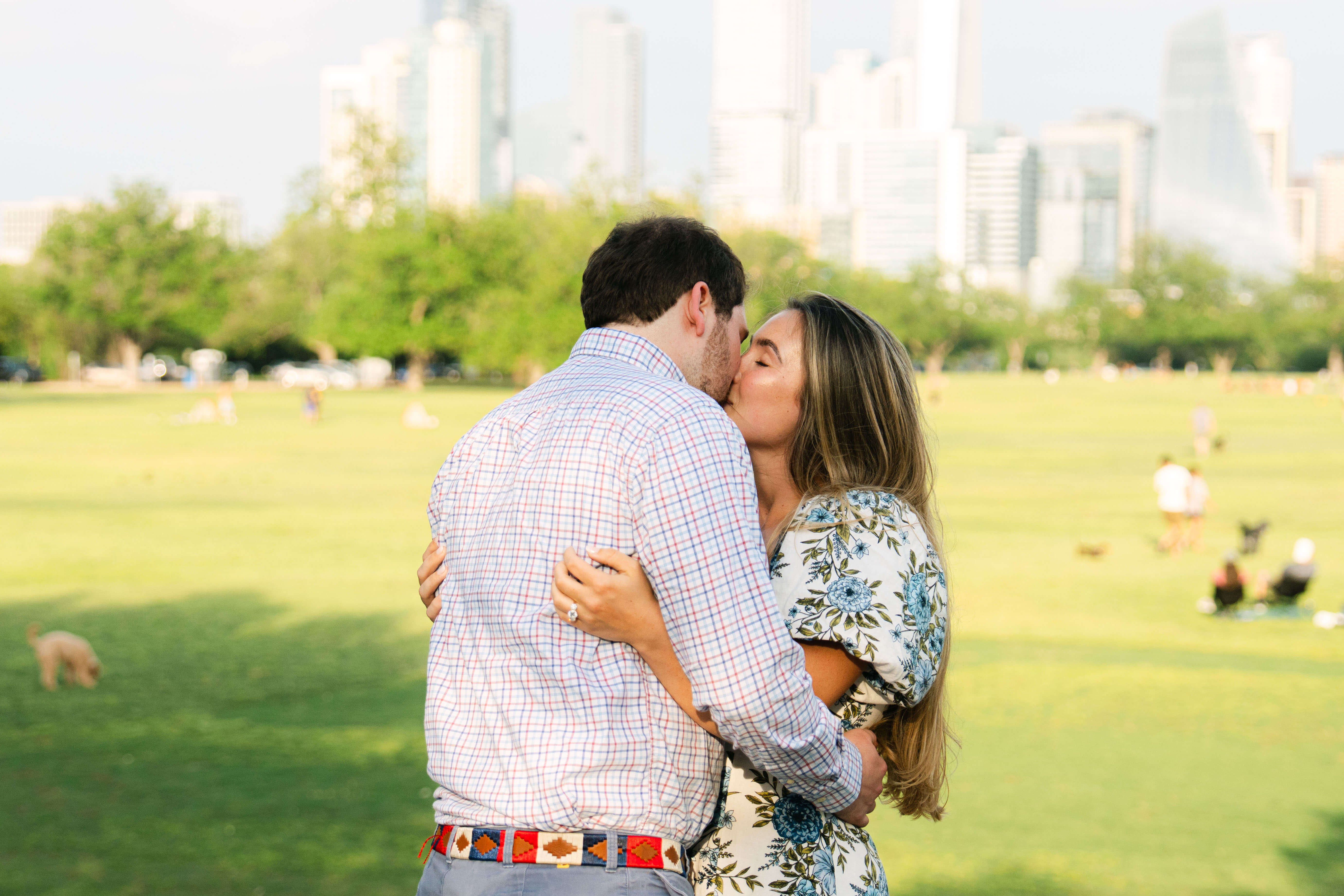Couple kissing at Zilker Park during surprise proposal in Austin