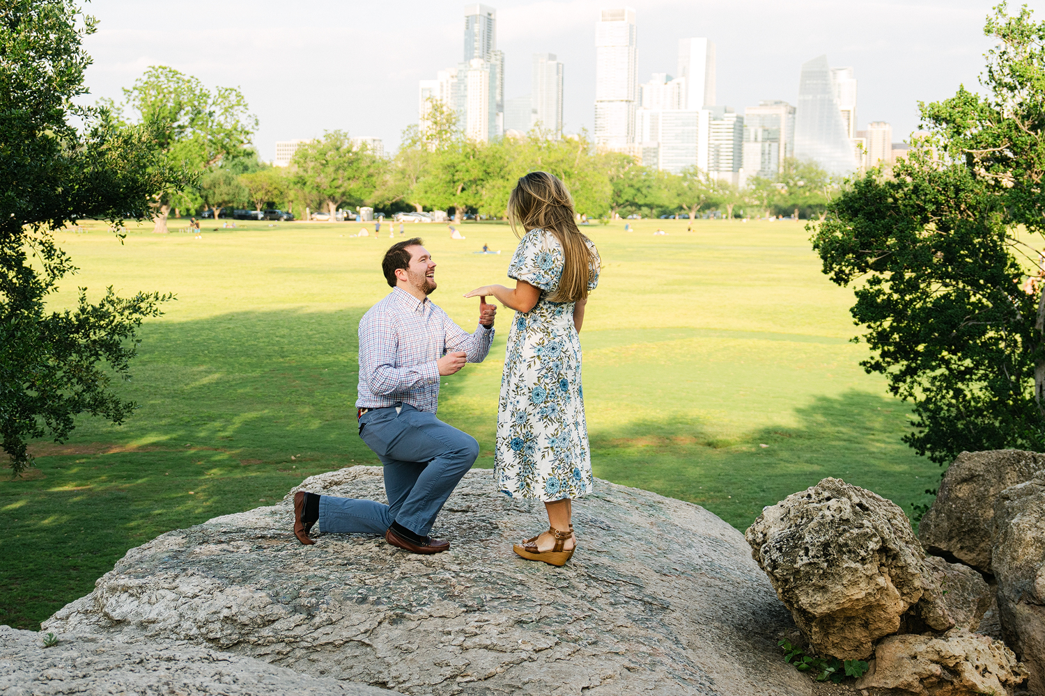 Surprise proposal at Zilker Park with Austin skyline in background — Moments by Marcela