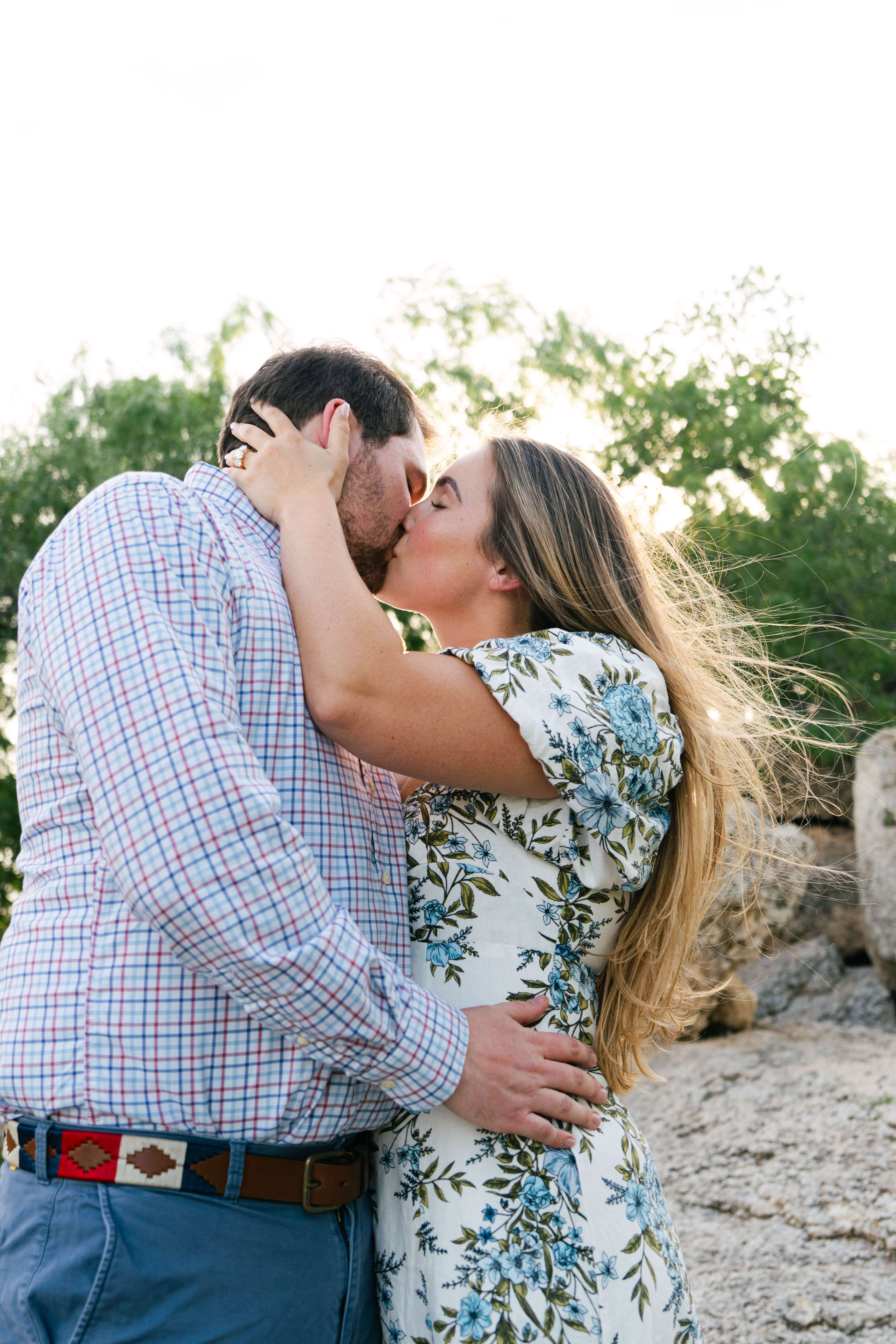 Newly engaged couple kissing at Rock Island in Zilker Park Austin