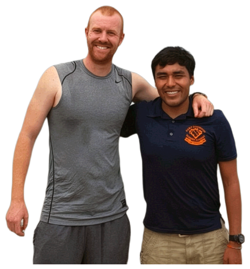 A Camp Dogwood counselor and camper standing side by side smiling