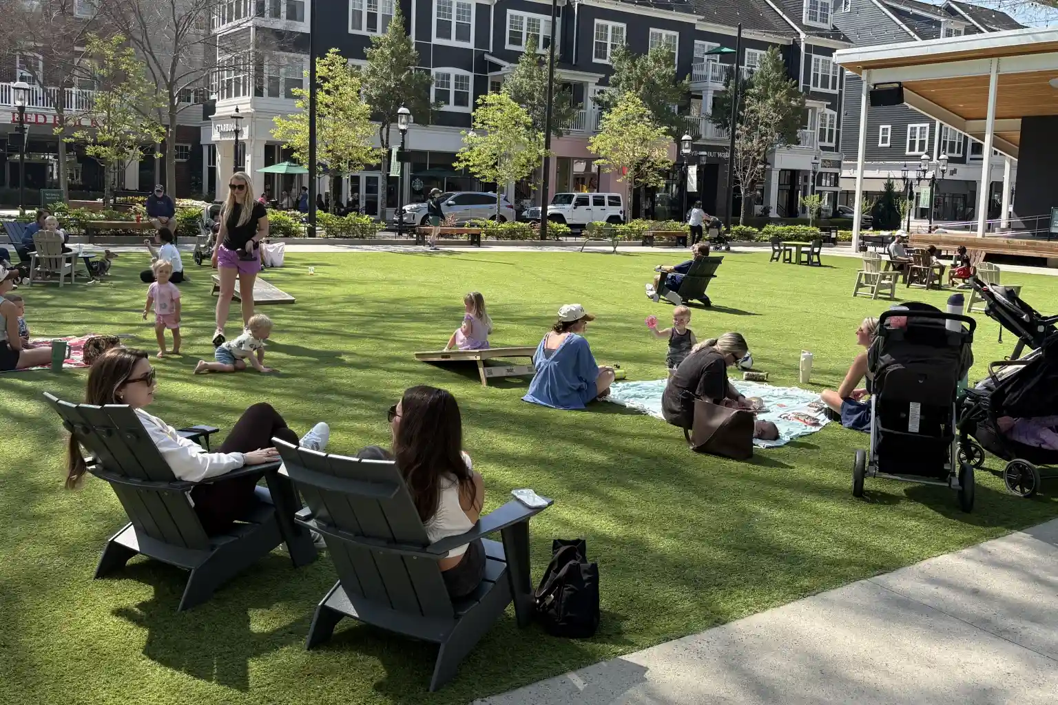 Families relaxing on the green at Birkdale Village in Huntersville, NC