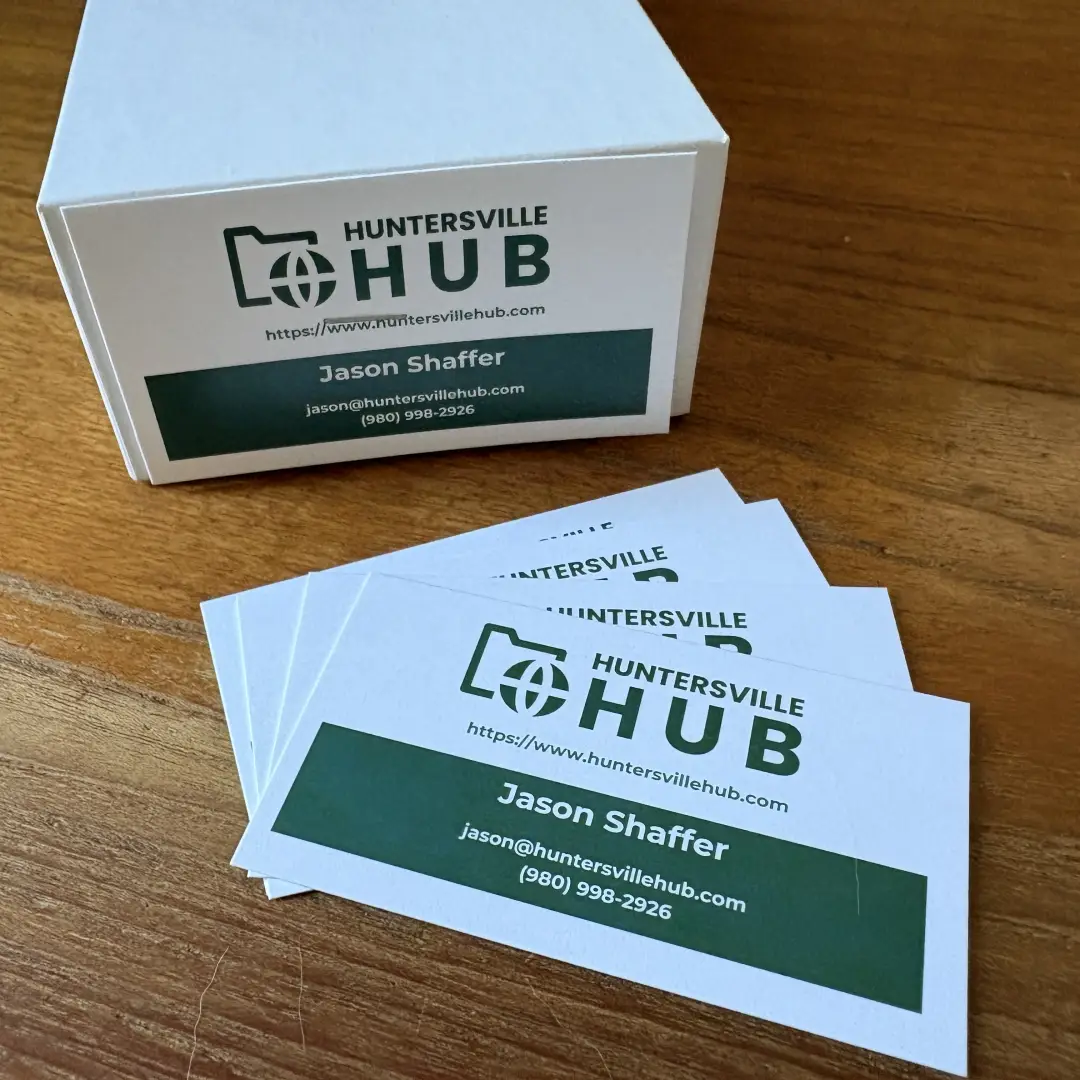 Huntersville Hub business cards on a wooden desk, printed by Lake Norman Graphics in Huntersville, NC