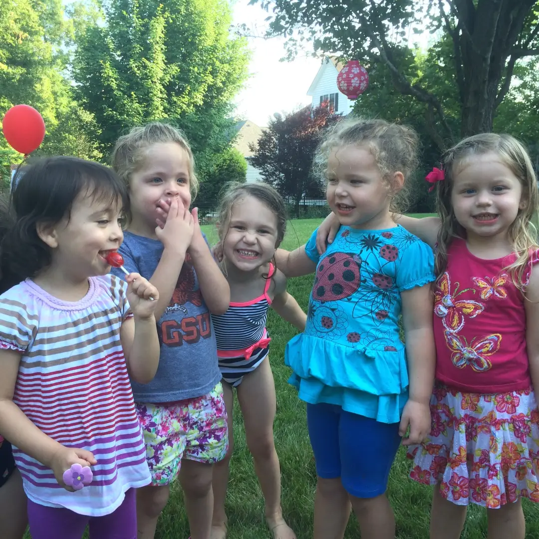 A group of smiling kids outside at a birthday party in Huntersville, NC