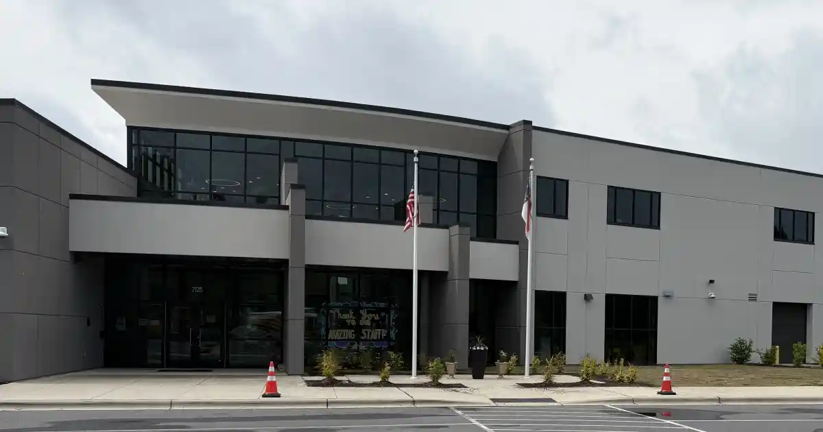 The exterior entrance of a school building in Huntersville, NC with American and North Carolina state flags