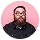 Bearded man with glasses wearing a black shirt against a pink background.