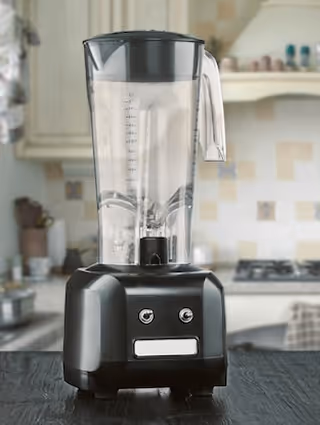 Black blender with a clear container on a kitchen countertop with tiled backsplash in the background.