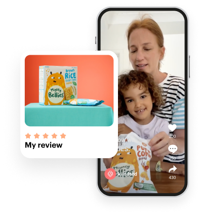 Woman and child sitting at a table with Mighty Bellies snacks, a positive product review is shown.