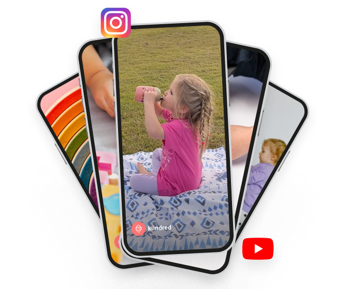 A child in a pink shirt drinks from a bottle sitting on a blanket outdoors, shown on a phone screen.