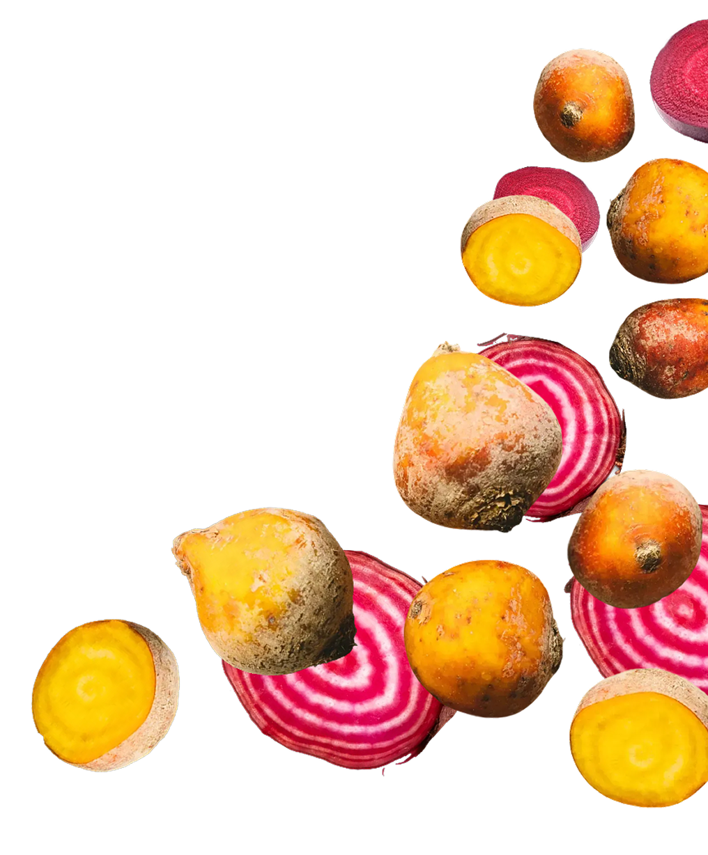Scattered golden and striped red beets, some whole and some sliced, on a black background.