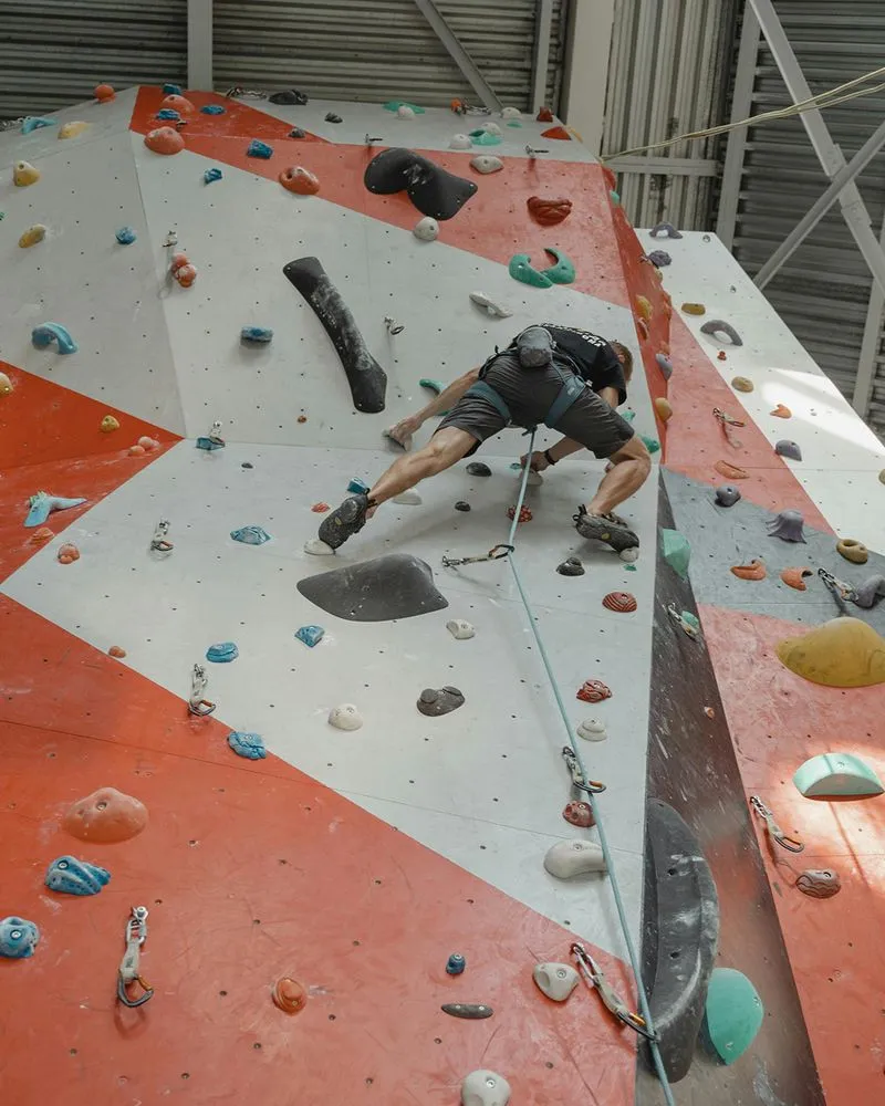 Climber on red and white wall